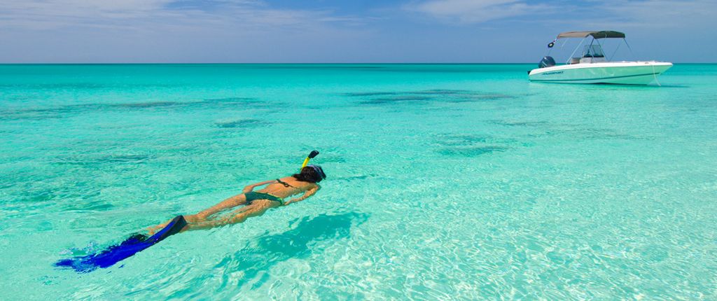 Diver in pristine turquoise water of grace bay beach near to the villa rental